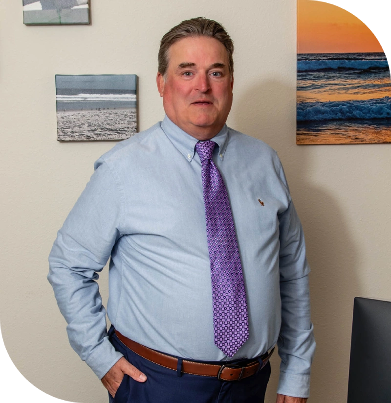 Man in blue shirt and purple tie.